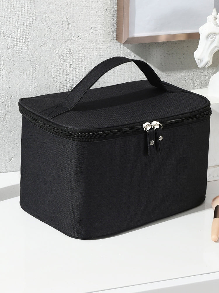 Black cosmetic bag on a white surface with a neutral background