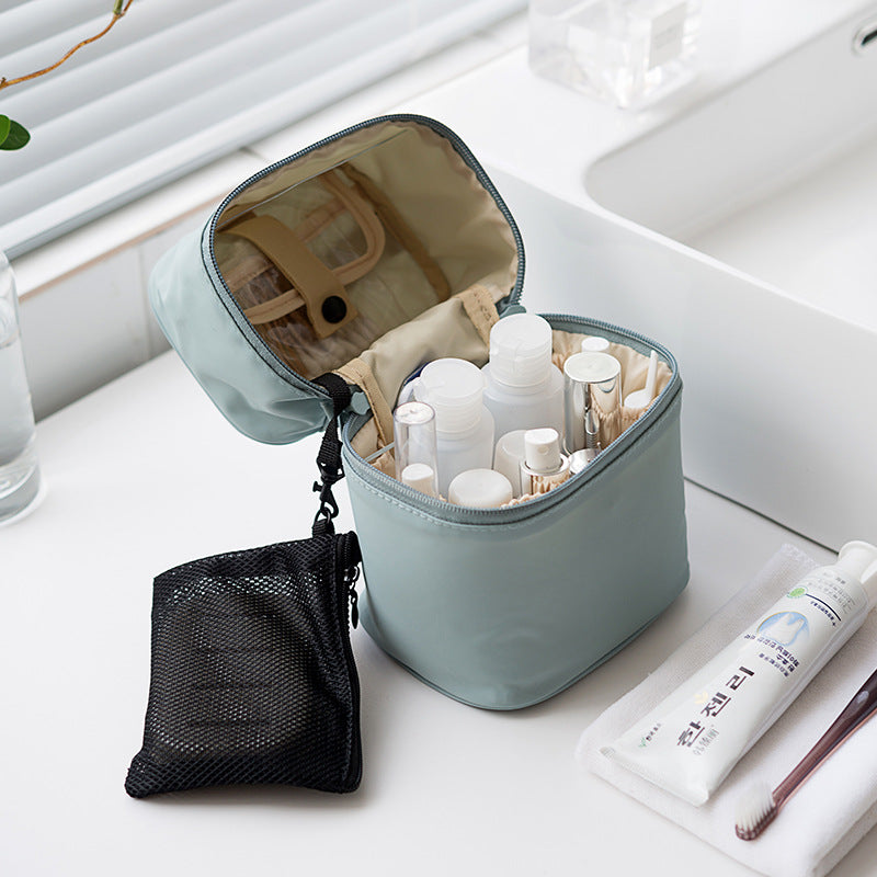 Cosmetic bag with toiletries on a bathroom counter