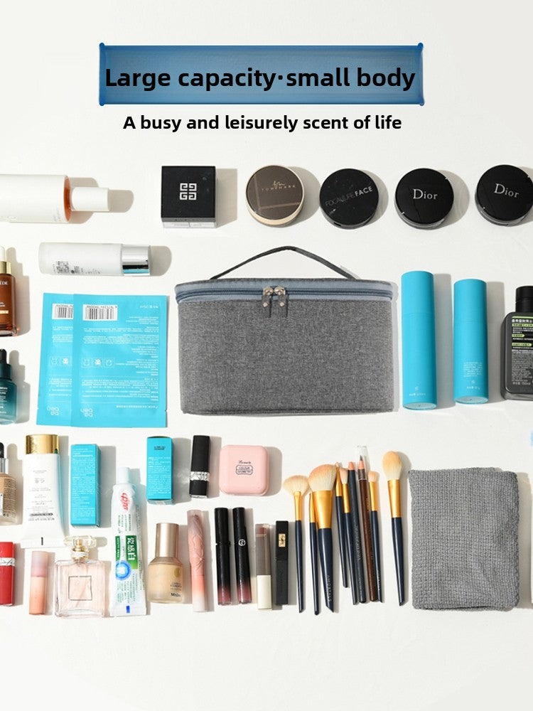 Collection of beauty products including makeup items and a gray cosmetic bag on a white background.